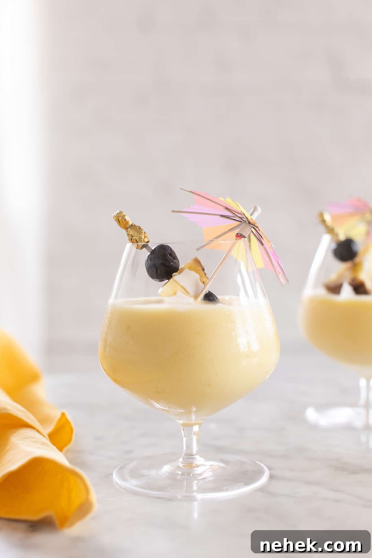 Creamy Non-Alcoholic Piña Colada Recipe 2 virgin piña colada recipe - coconut cream, frozen pineapple chunks, tropical drink, maraschino cherries, coconut cream, pina coladas