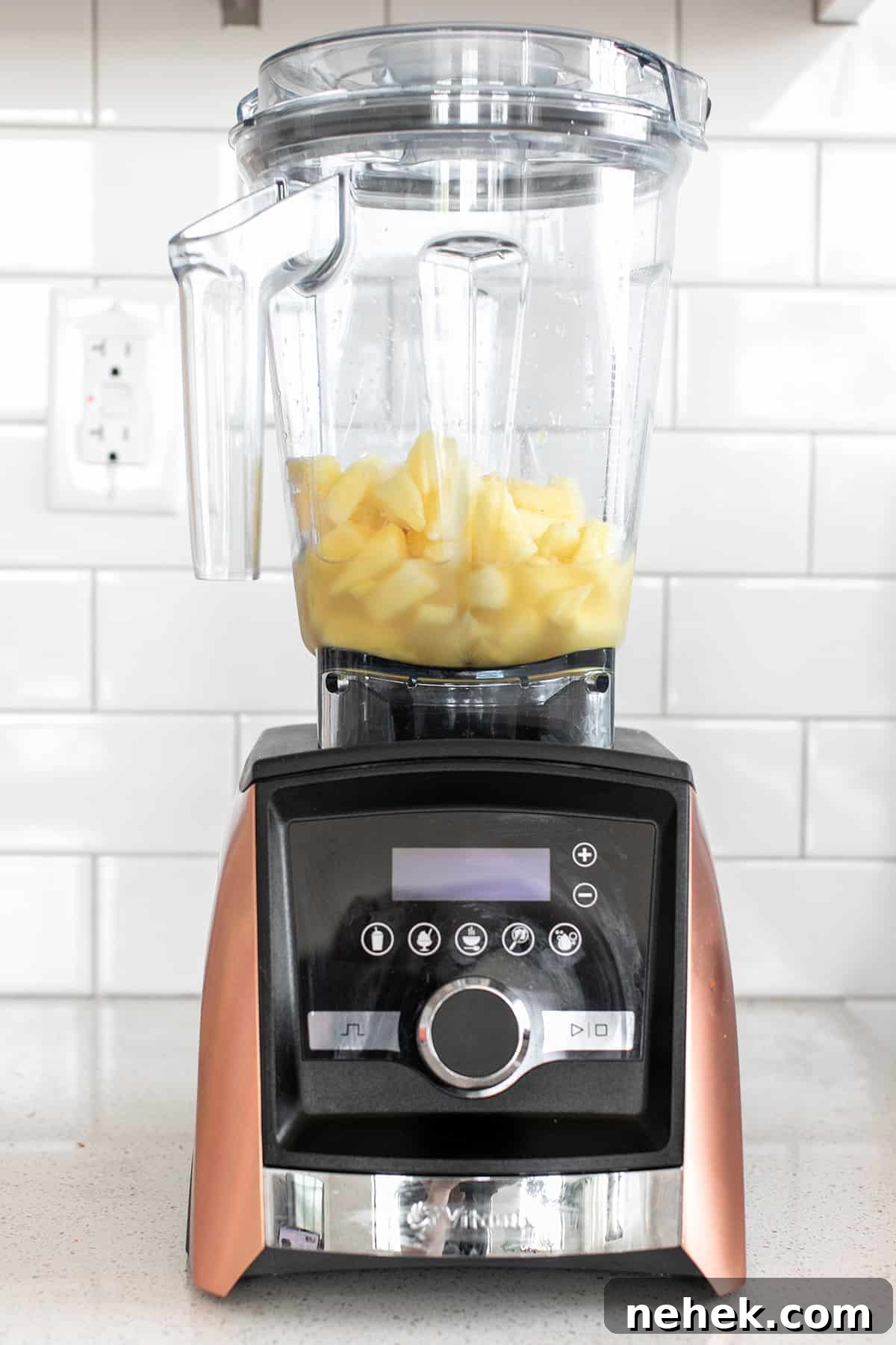 Creamy Non-Alcoholic Piña Colada Recipe 3 frozen pineaple and coconut in a blender - piña colada, frozen pineapple chunks, fresh lime juice, cream of coconut, pineapple slice, pina coladas
