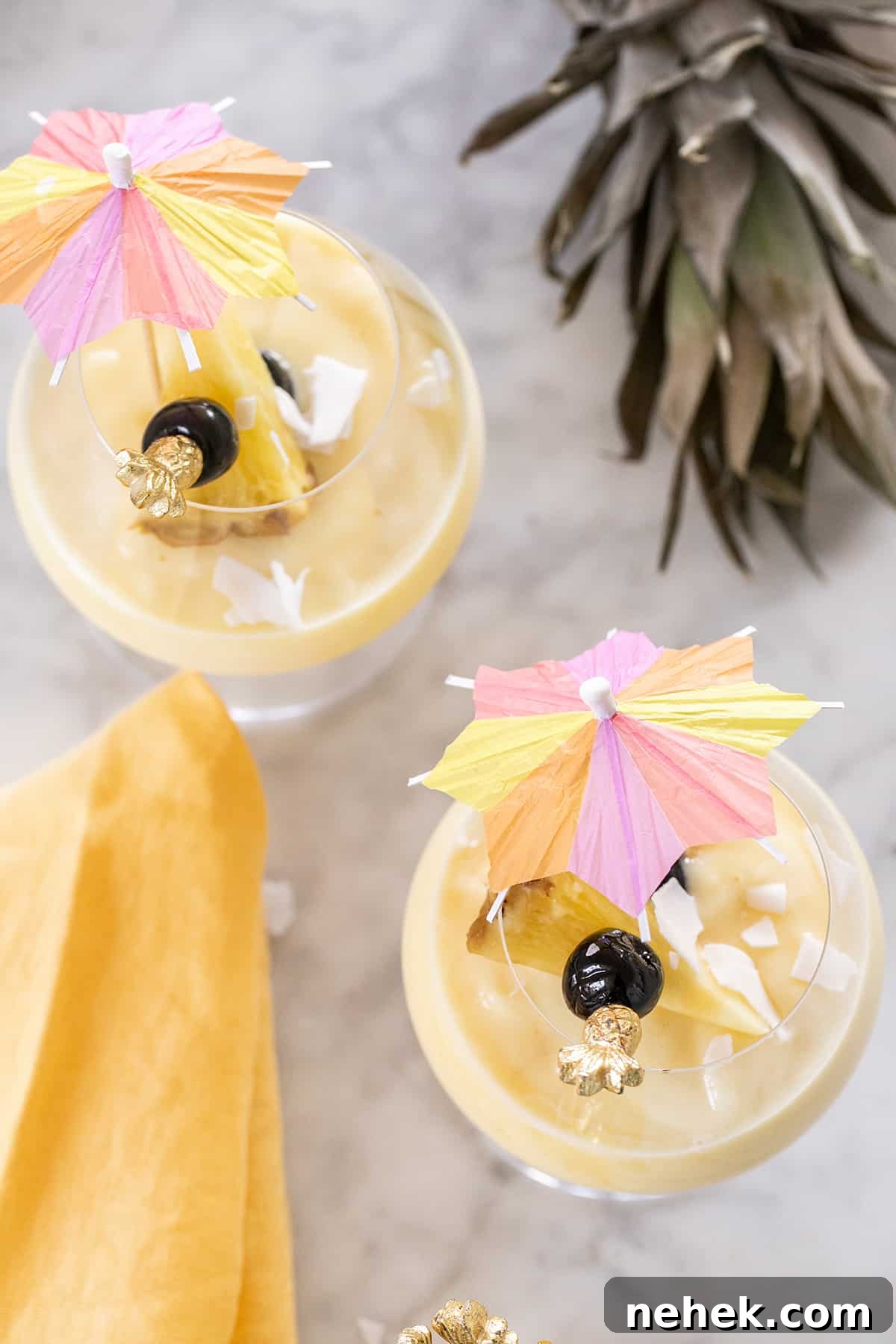 Creamy Non-Alcoholic Piña Colada Recipe 5 best virgin pina colada recipe with a cocktail umbrella - coconut cream, coconut milk, cream of coconut, white rum, piña coladas