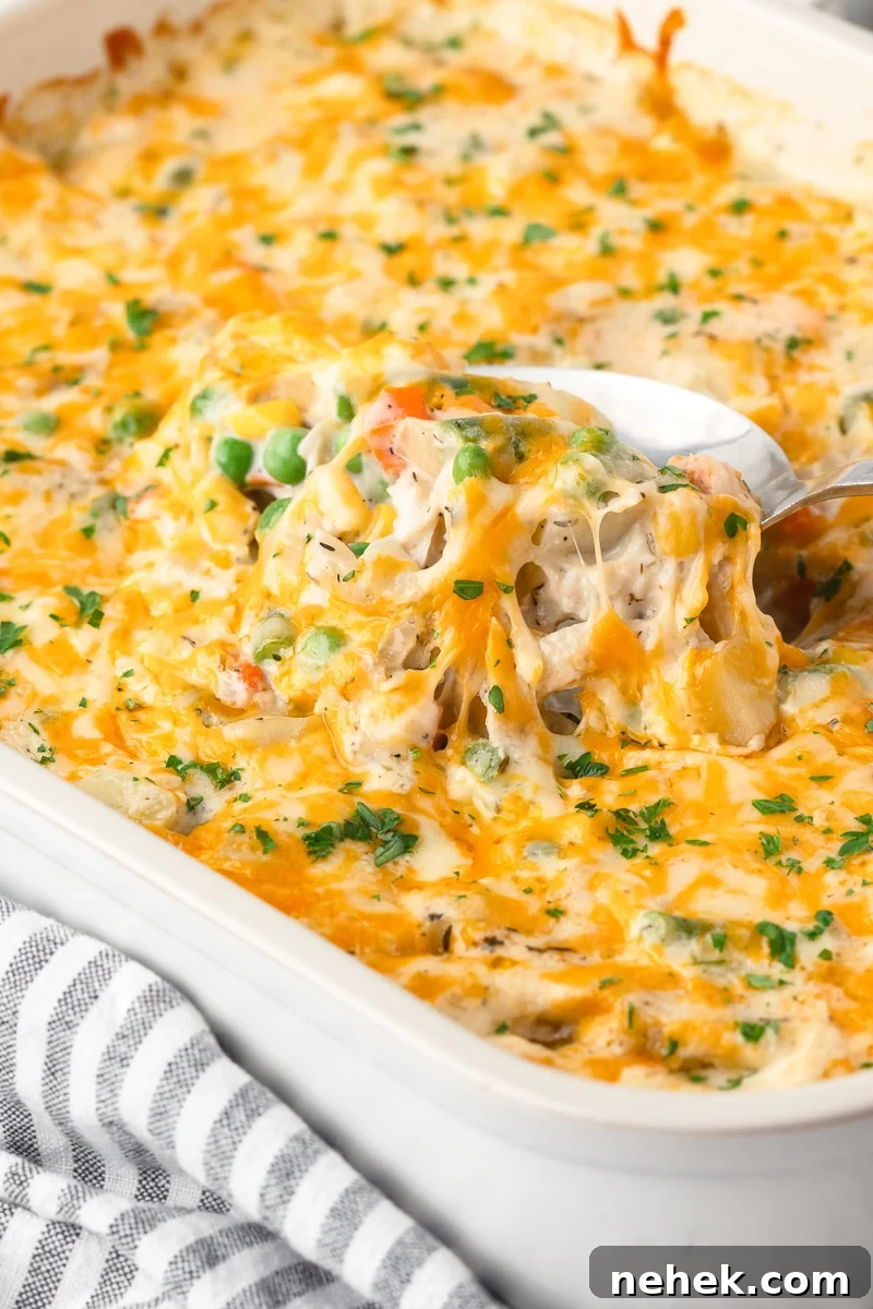 One-Pan Chicken and Potato Casserole with Crispy Top 6 Scoop of casserole is lifted from casserole dish.