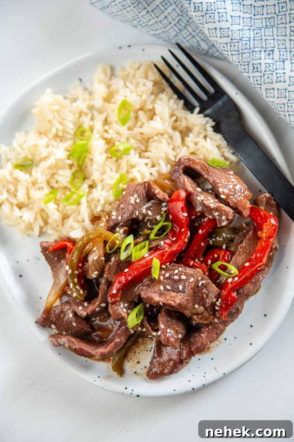 Slow Cooker Pepper Steak: Tender Beef with Peppers & Onions 2 slow cooker pepper steak served on plate