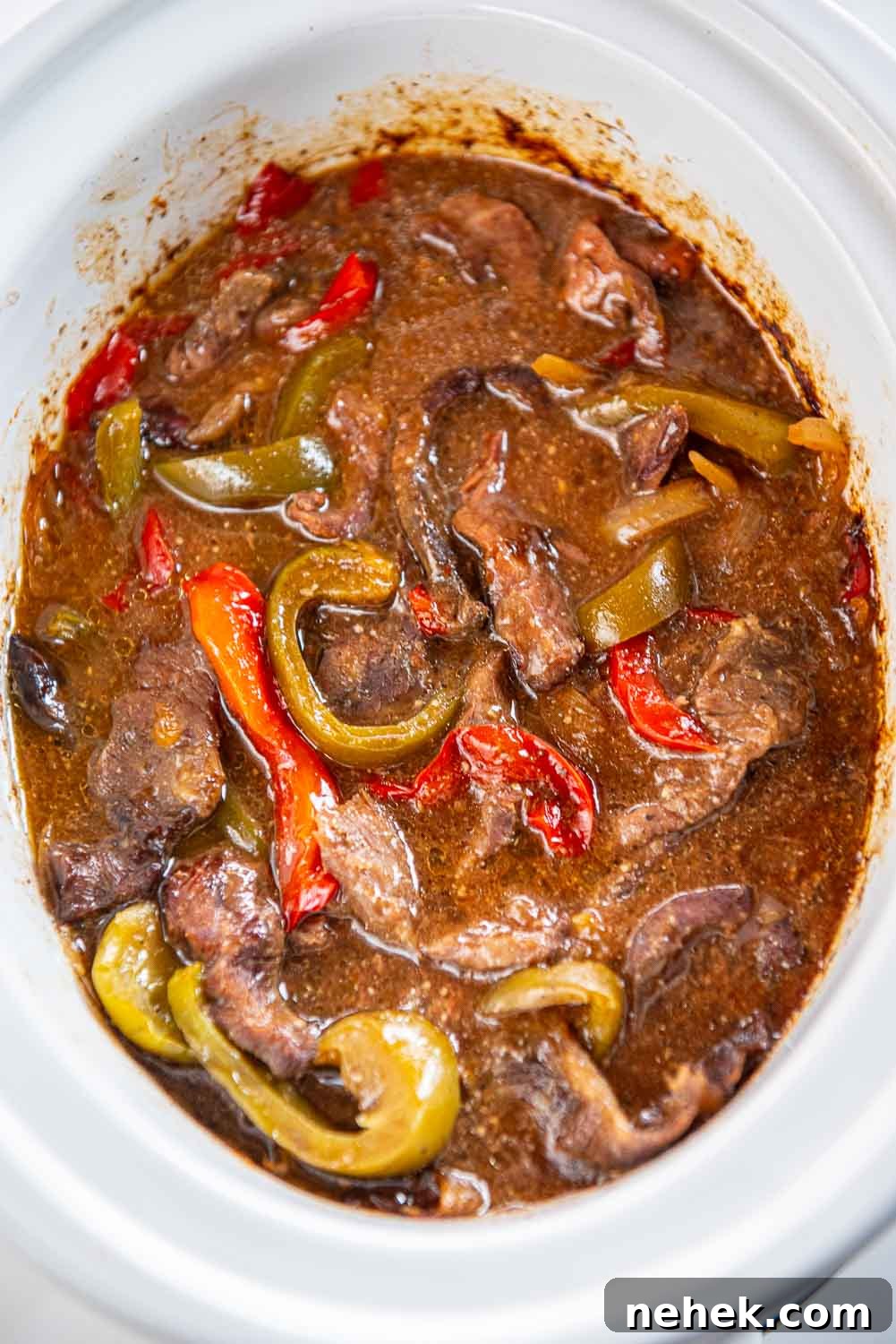 Slow Cooker Pepper Steak: Tender Beef with Peppers & Onions 8 Pepper Steak cooking in slow cooker