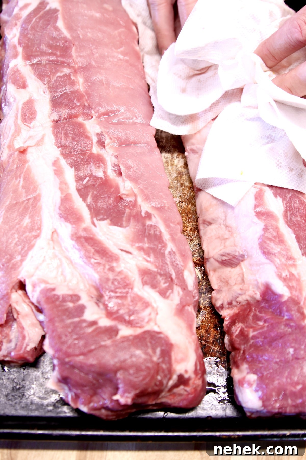 Baby Back Ribs recipe on the grill. patting ribs dry with paper towels
