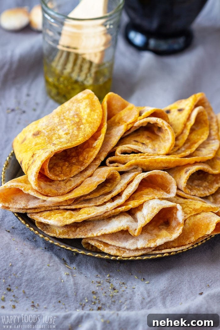 Homestyle Pumpkin Flatbread Recipe for Fall Gatherings 2 Stack of freshly cooked pumpkin flatbreads on a plate.