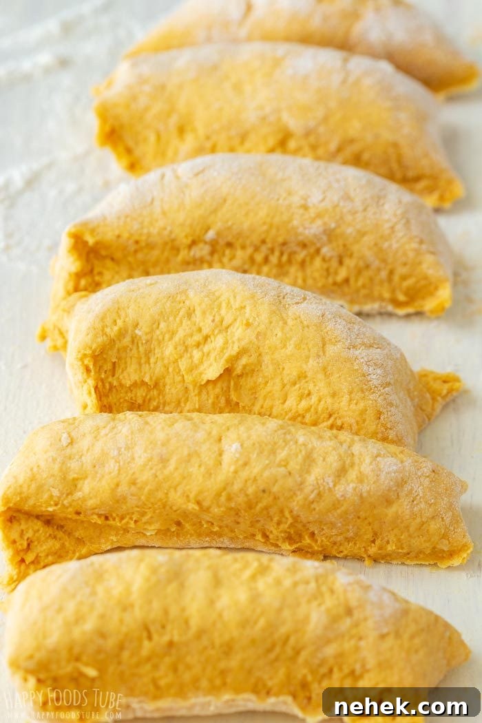 Homestyle Pumpkin Flatbread Recipe for Fall Gatherings 6 Portions of pumpkin flatbread dough cut and ready to roll.
