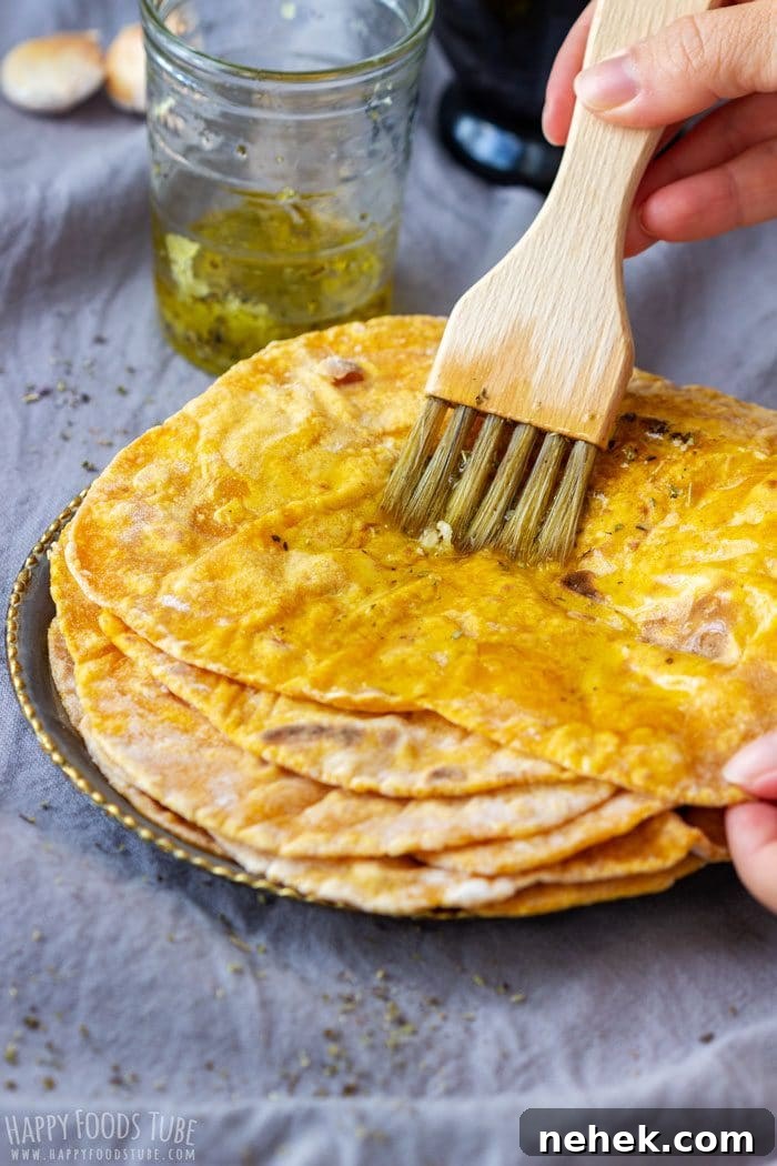 Homestyle Pumpkin Flatbread Recipe for Fall Gatherings 8 Brushing warm pumpkin flatbread with garlic and herb oil.
