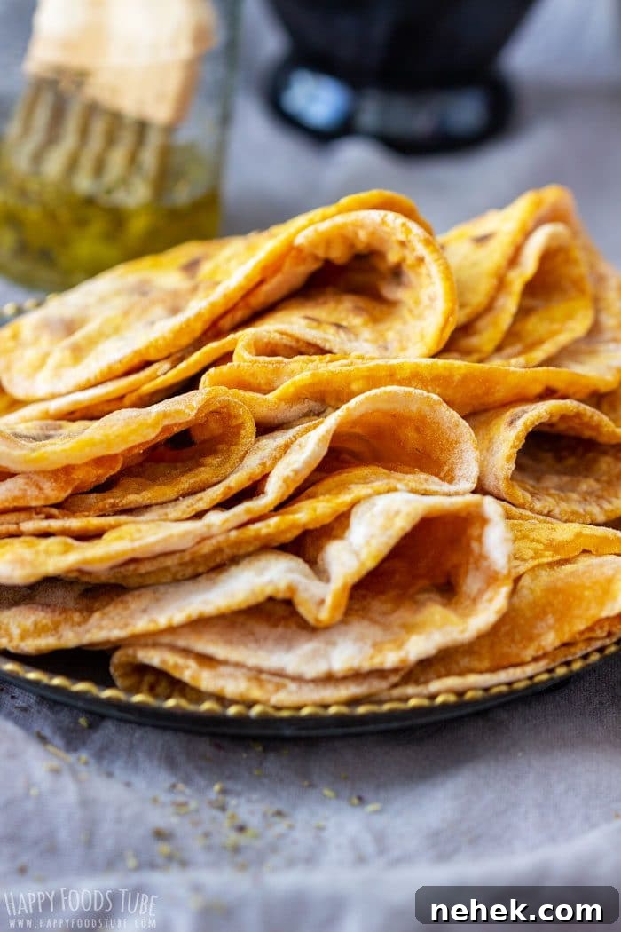 Homestyle Pumpkin Flatbread Recipe for Fall Gatherings 9 Homemade pumpkin flatbread stacked on a plate ready to serve.