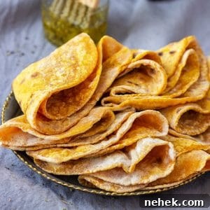 Homestyle Pumpkin Flatbread Recipe for Fall Gatherings 10 Freshly cooked pumpkin flatbread stacked on a plate, ready to serve.