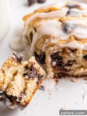 A chocolate chip sourdough scone with a fork taking a piece out of it.