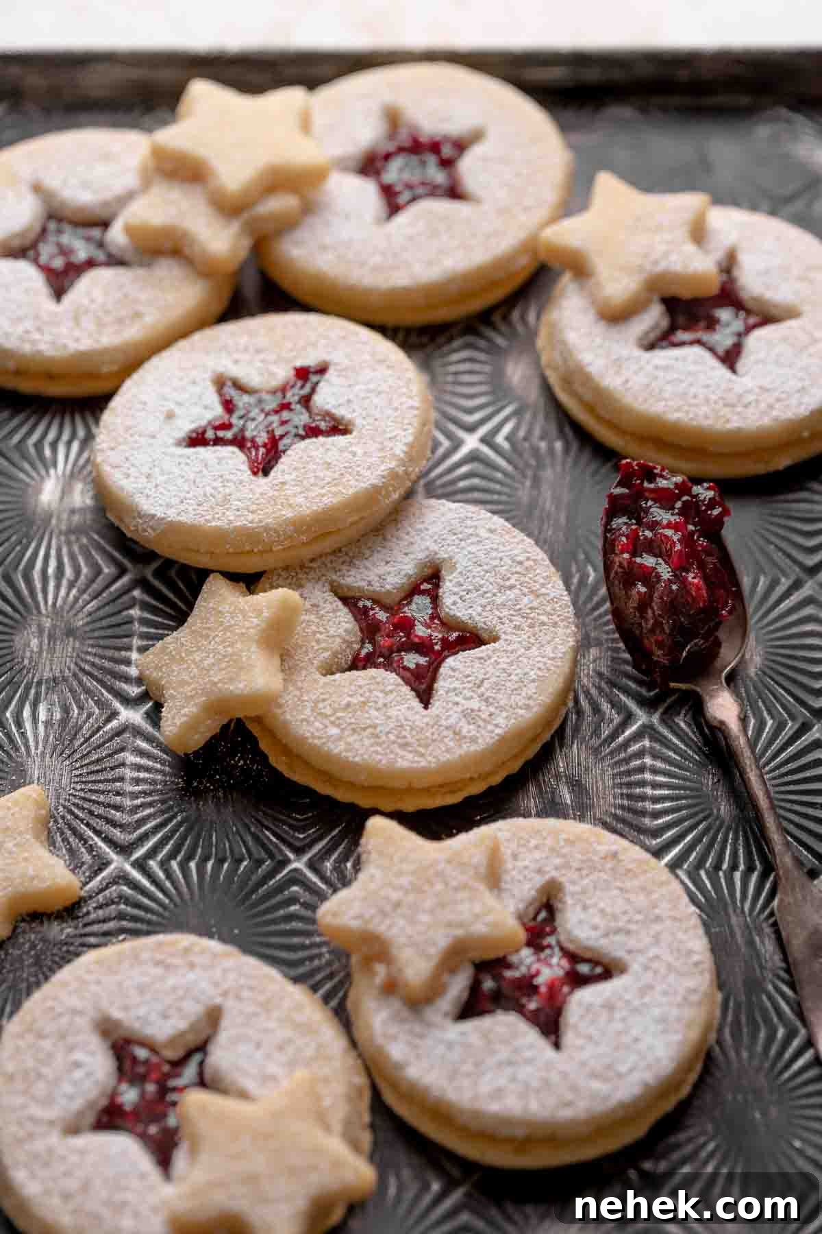 Raspberry Jam Linzer Shortbread Cookies 8 shortbread linzer cookies filled with raspberry jam and dusted with powdered sugar.