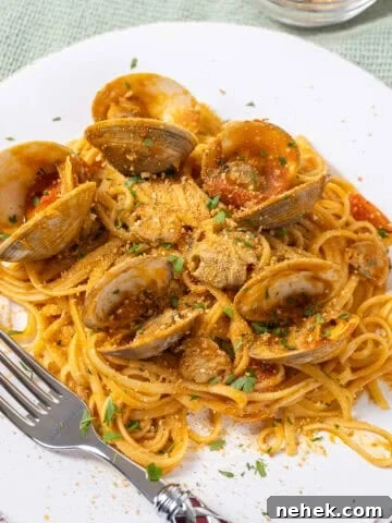 linguine with clams in red sauce on a plate.