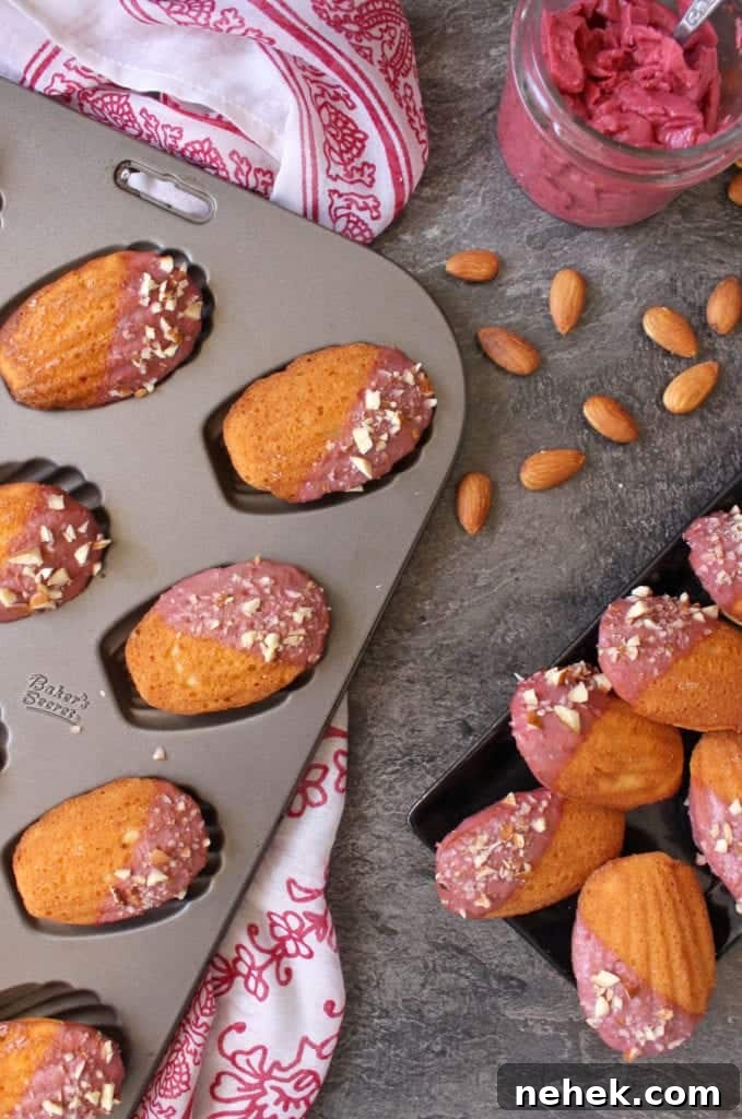 Almond Madeleines with Raspberry Glaze Recipe 5 Madeleine in the pan and over a black rectangular plate from above