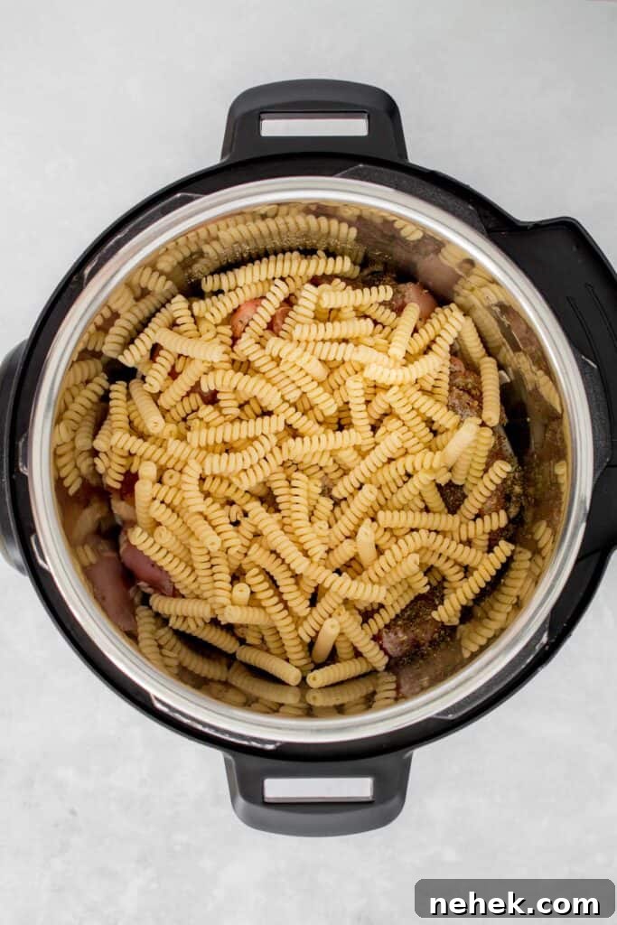 Creamy Instant Pot Chicken Pesto Pasta 7 Pasta added to the Instant Pot.