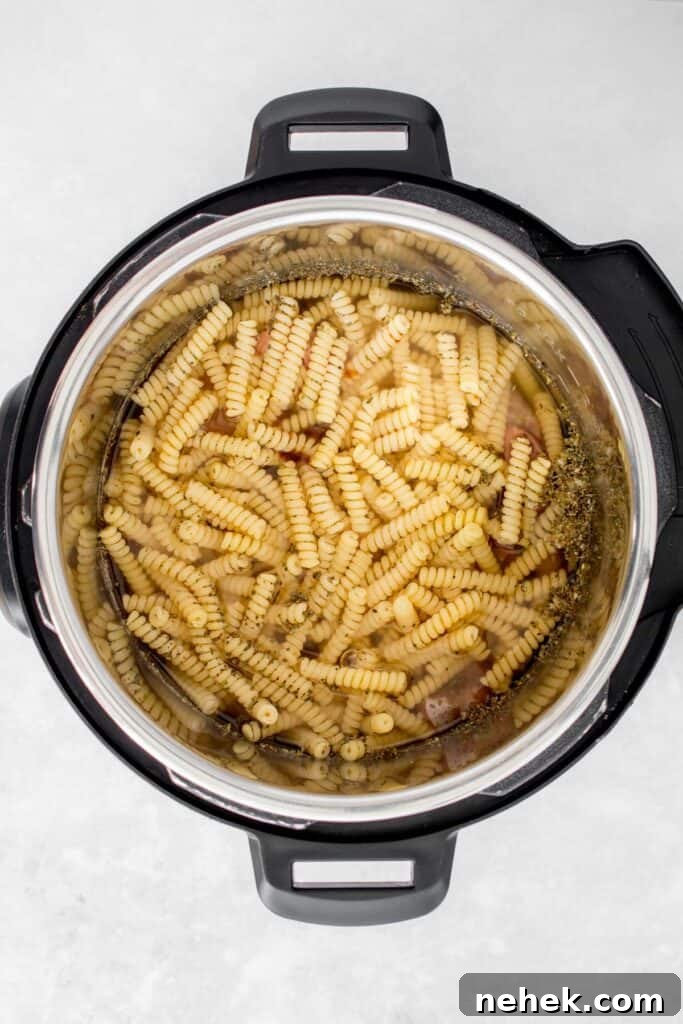 Creamy Instant Pot Chicken Pesto Pasta 8 Vegetable broth added to the Instant Pot.
