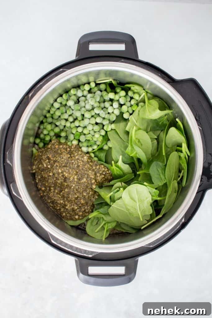 Creamy Instant Pot Chicken Pesto Pasta 10 Peas, spinach, and pesto added to the pasta in the Instant Pot.