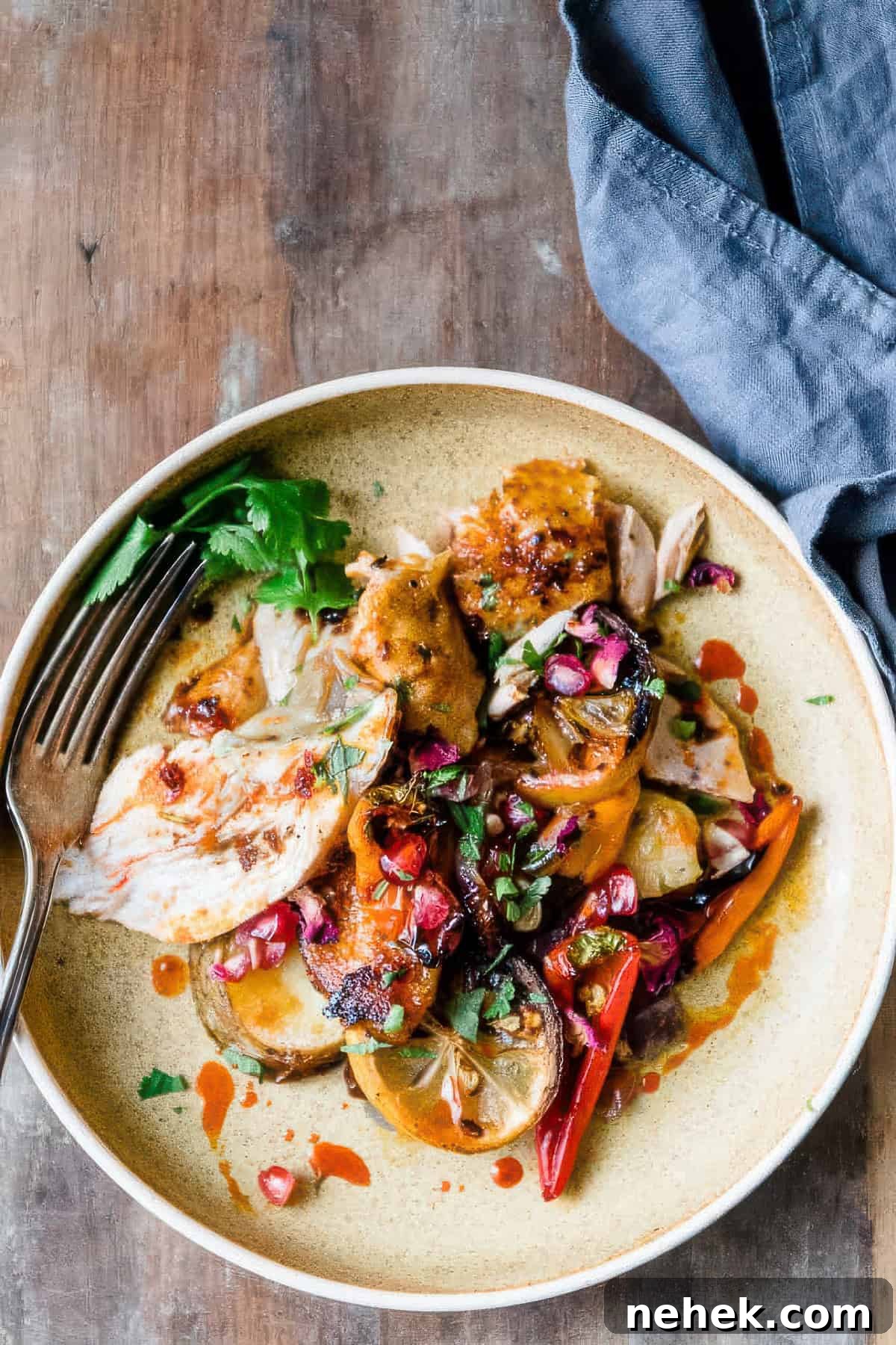 Sheet Pan Harissa Chicken with Crispy Potatoes 4 Sliced harissa chicken with roasted vegetables.