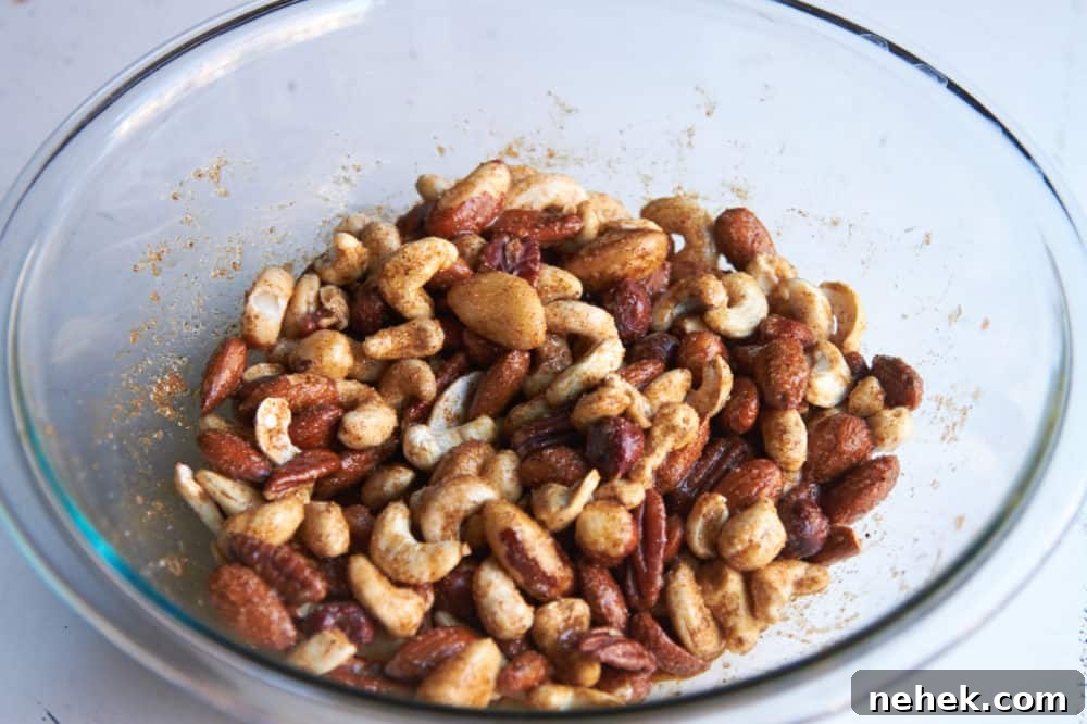 Sweet and Spiced Roasted Nuts 4 Mixed nuts coated with egg whites and spices in a glass bowl.
